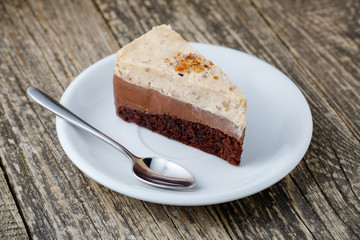 Tasty nuts cake on wooden background.