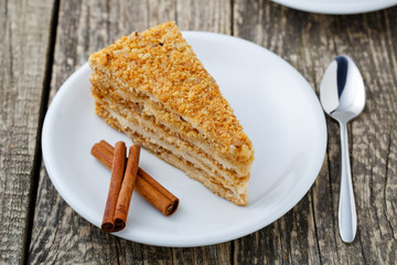 Tasty honey cake on wooden background.