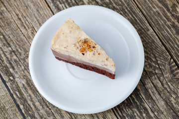 Tasty nuts cake on wooden background.