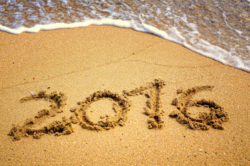 happy 2016 written on the sand
