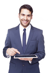 Smiling business man pointing to a tablet computer, isolated on