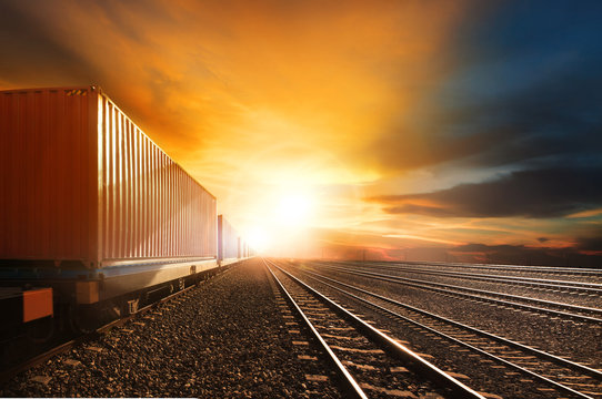 Fototapeta industry container trains running on railways track against beau