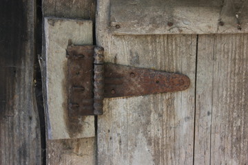 Old door hinge on old wooden door