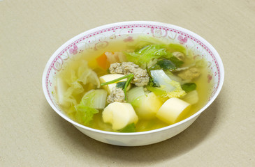 clear soup with bean curd and minced pork in dish on cardboard b