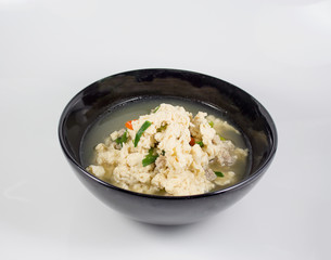 Fried Eggs in Clear Soup in black bowl on white background