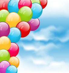 Flying colourful balloons in blue sky