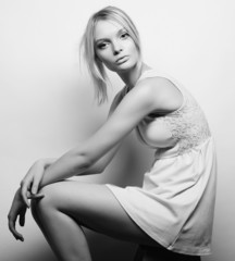 beautiful blonde model sitting on a stool