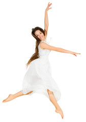 Young dancing girl in white dress