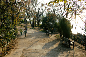 mother with sons in park walking at sunrise