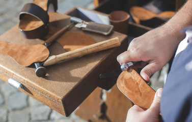 Hands making shoes