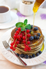 Pancake with honey and berries