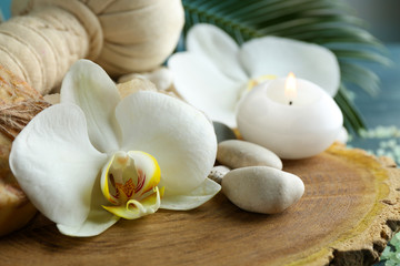 Fototapeta na wymiar Still life with beautiful blooming orchid flower, spa treatment on wooden background