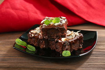 Delicious chocolate cakes on plate on table close-up