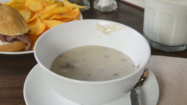 Ladling mushroom soup into a bowl

