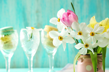 Spring bouquet in vase on color wooden background