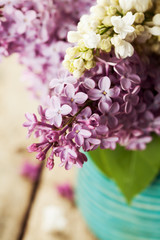 Brunches of white and purple lilac in vase