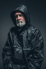 Reflective Man in Jacket Smoking a Cigarette