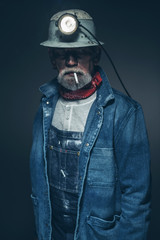 Reflective Senior Miner in Denim Jacket with Smoke