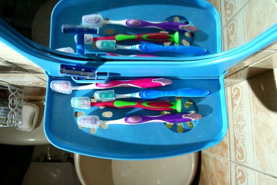 Toothbrushes On A Bathroom Organizer With A Mirror