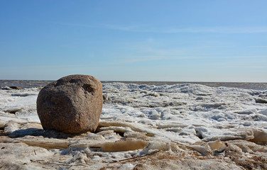 Fototapeta na wymiar Coastal line with ice and sea. Spring season