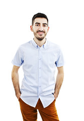 Young man standing with hands in pockets