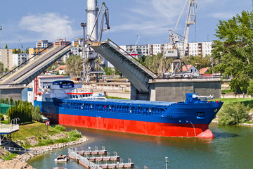 Cargo ship goes through bascule bridge in Slovakia city Komarno.