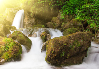 Beautiful small waterfall landscape in the mountains.