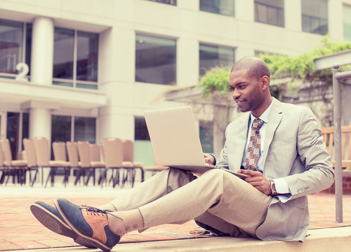 businessman working on laptop outdoors