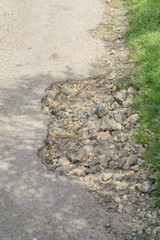 Pot hole closeup of countryside road