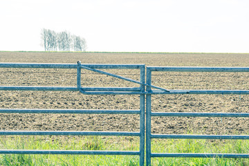 Metal gate into the fields in rural Suffolk in England