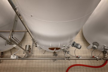 Fototapeta na wymiar Large industrial white silos in modern factory