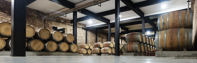   winery with  many wooden barrels