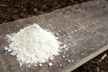 pile of flour on a rustic wooden board