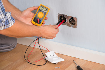 Person Hand Checking Socket Voltage