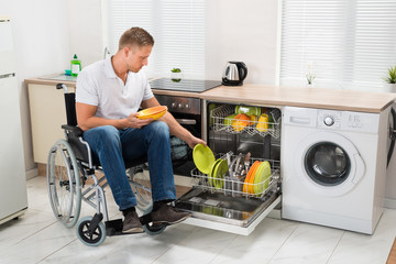 Disabled Man Working In Kitchen