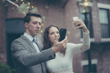 Bride and groom doing selfies in vintage pastel colors