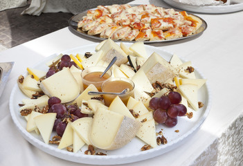 plate of mixed cheeses with pears and jams