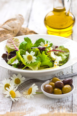 Summer leaf salad on a wooden background