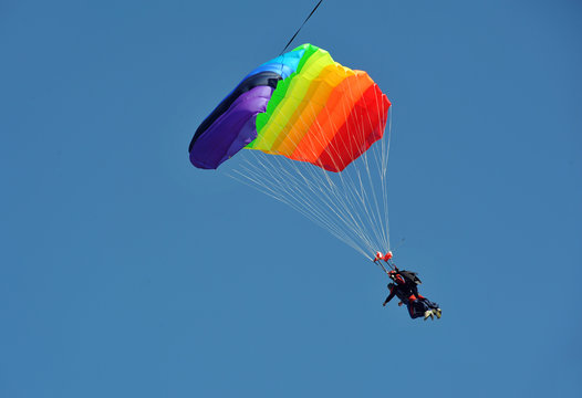  Tandem parachute against blue sky
