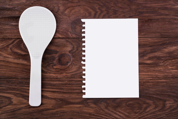 Plastic spoon and sheet of paper