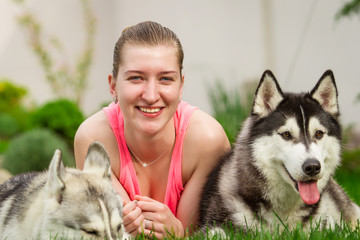 beautiful young girl playing with dog outdoo