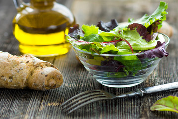 Summer salad in a cup on a wooden background
