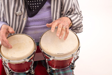 Fototapeta na wymiar Funny elderly lady playing bongo.
