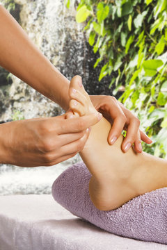 Foot massage in the spa salon in the garden.