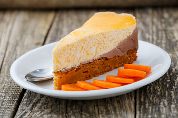 Sweet slice of carrot cake on white plate.