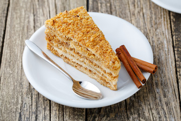 Tasty honey cake on wooden background.