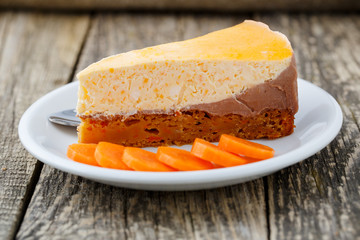 Sweet slice of carrot cake on white plate.