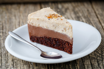 Tasty nuts cake on wooden background.