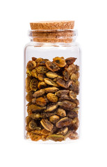 Obraz premium Dried sophora japonica beans in a bottle with cork stopper for m
