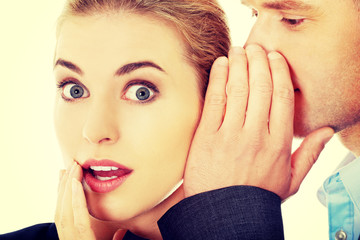 Men whispering secret to his friend